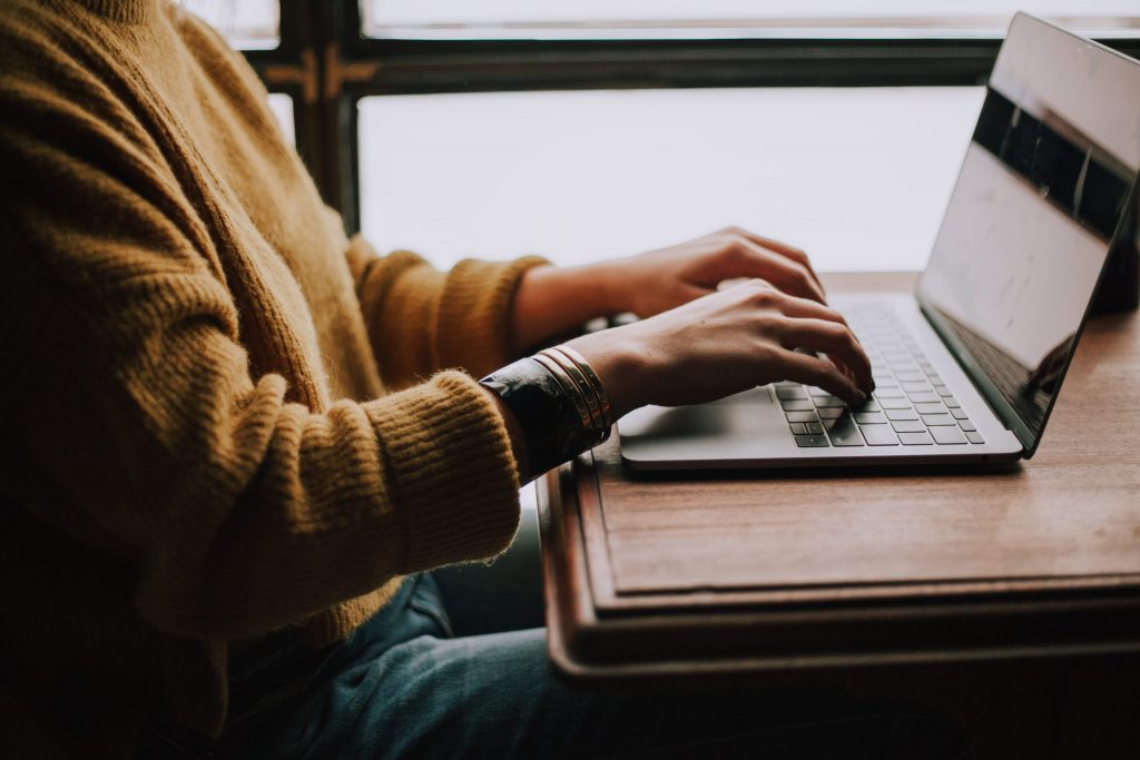 A student audio typing on laptop