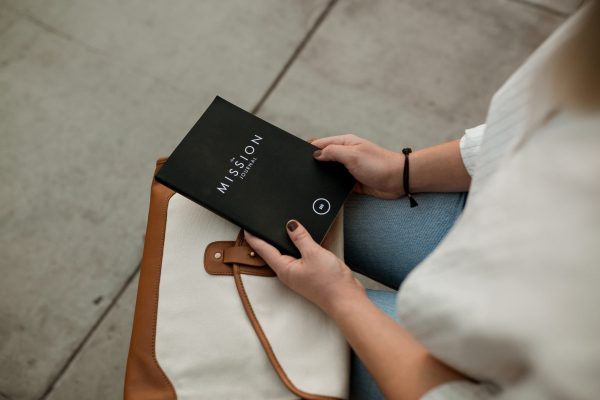 Woman holding mission journal