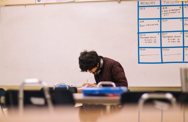 Student writing in classroom