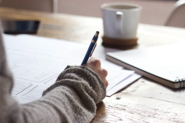 Person writing with pen