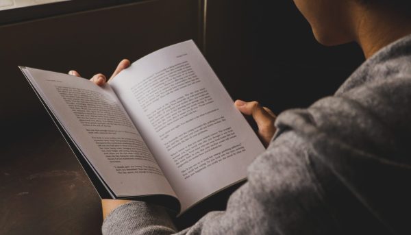 Person reading paperback book