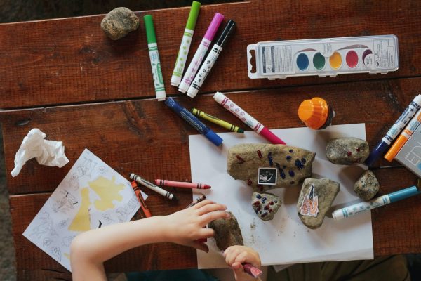 Markers and paint on a table