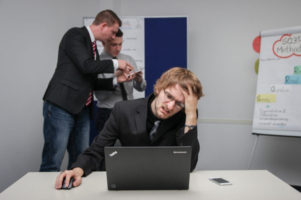 A visibly upset man browsing his laptop