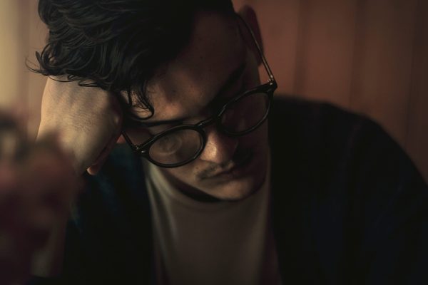 Depressed looking man wearing glasses