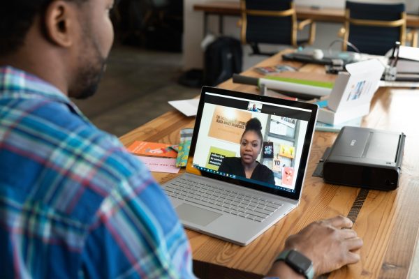 Man using laptop to talk with lady.