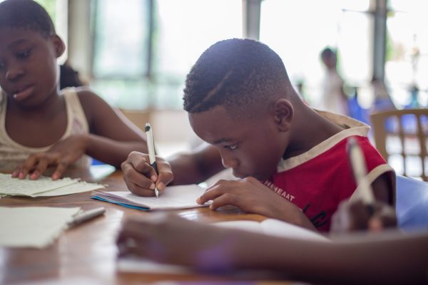 Student writing on a desk