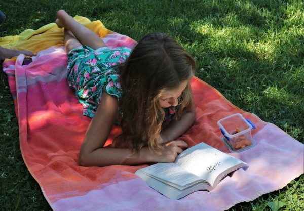 Student reading and eating carrots